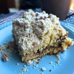 a pieces of sour cream coffee cake on a blue plate